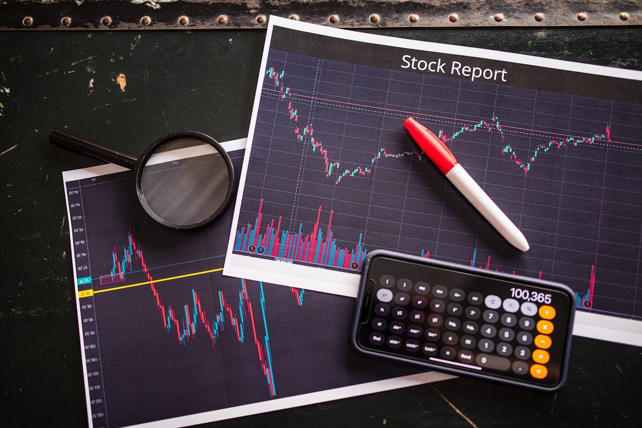 About Stock report with charts, calculator, and magnifying glass for financial analysis.